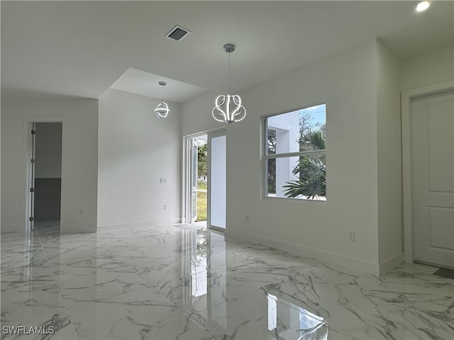 unfurnished room with a notable chandelier and a healthy amount of sunlight