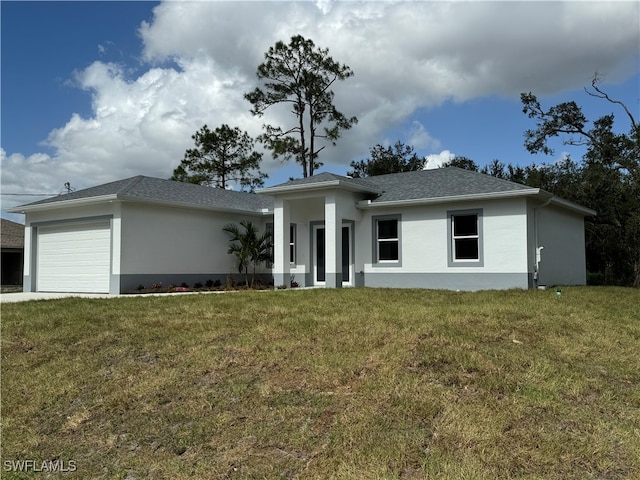 view of front of home with a front lawn and a garage