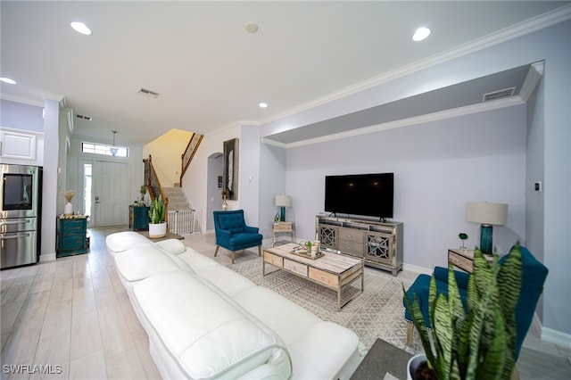 living room featuring light wood-type flooring and ornamental molding