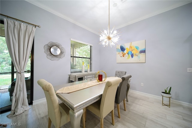 dining space featuring light hardwood / wood-style flooring, ornamental molding, and an inviting chandelier