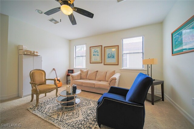 living room featuring ceiling fan and light colored carpet