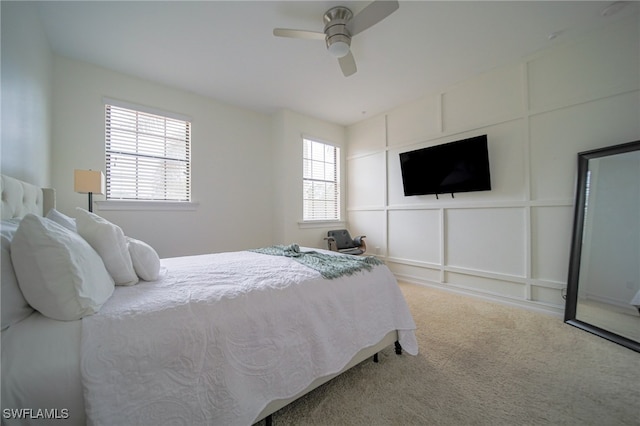 carpeted bedroom with multiple windows and ceiling fan