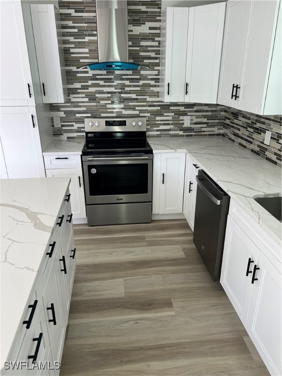 kitchen featuring stainless steel appliances, extractor fan, and white cabinets