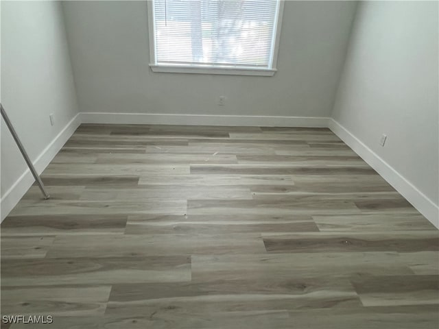 empty room with light hardwood / wood-style flooring