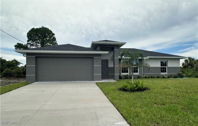 view of front of house featuring a garage and a front lawn