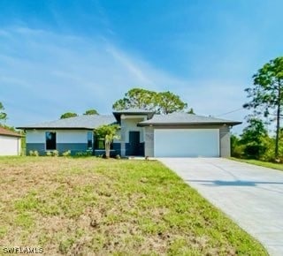 view of front of property featuring a garage and a front lawn