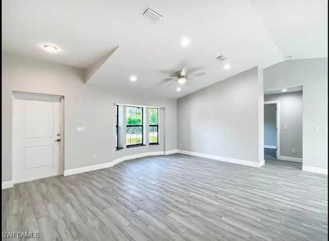 unfurnished room with ceiling fan, light hardwood / wood-style floors, and lofted ceiling