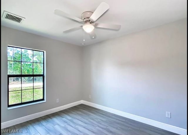 empty room featuring ceiling fan and dark hardwood / wood-style flooring