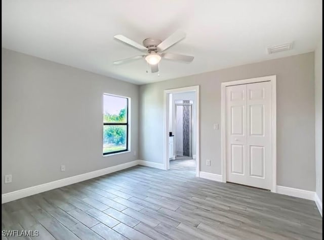 unfurnished bedroom with a closet, ceiling fan, and light hardwood / wood-style flooring