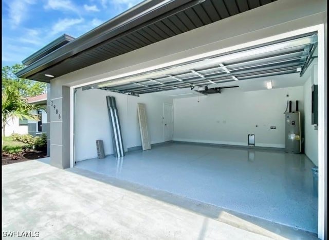 garage featuring a garage door opener and water heater