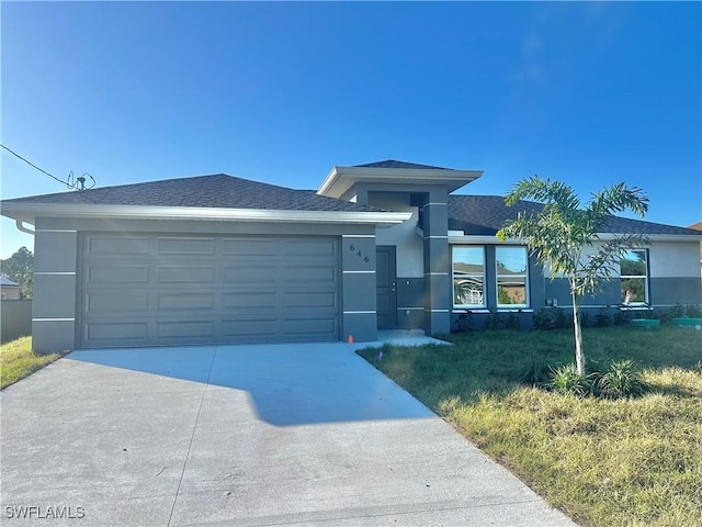 view of front of property with a garage and a front lawn