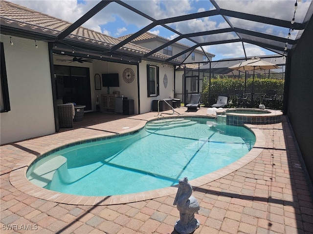 view of swimming pool featuring an in ground hot tub, a patio area, and glass enclosure