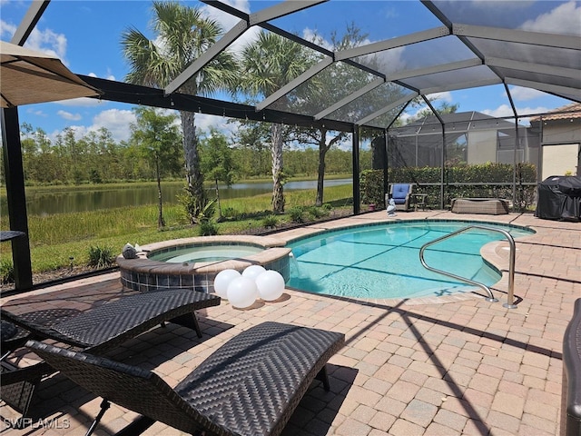 view of swimming pool with a patio area, an in ground hot tub, a water view, and glass enclosure