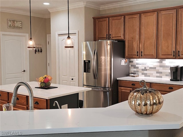 kitchen featuring stainless steel fridge, backsplash, a kitchen island, ornamental molding, and pendant lighting