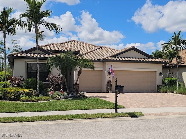 mediterranean / spanish-style home with a garage