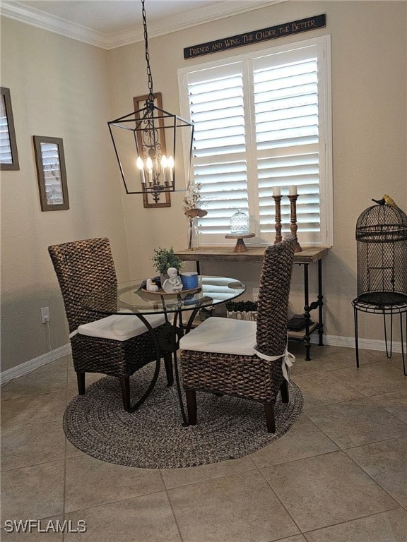 dining space with ornamental molding, an inviting chandelier, and tile patterned flooring