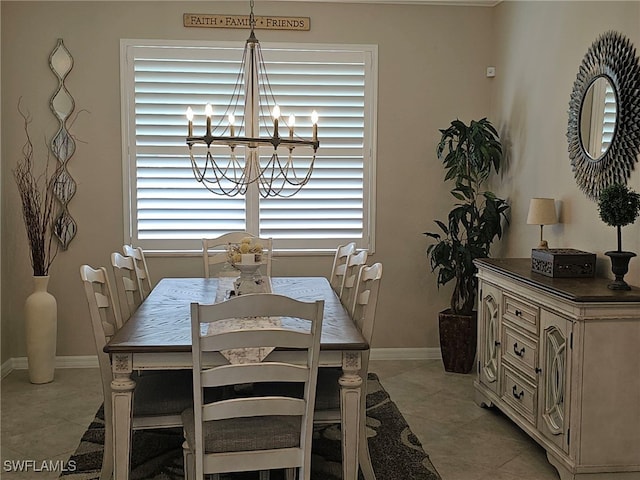 tiled dining area with a chandelier