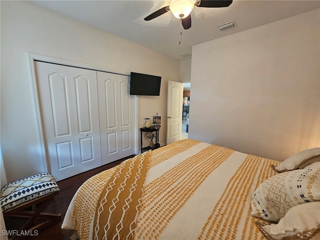 bedroom featuring dark hardwood / wood-style floors, a closet, and ceiling fan