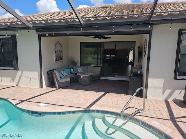 view of pool with ceiling fan, a lanai, a patio area, and an outdoor hangout area