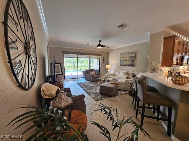 tiled living room featuring crown molding, a textured ceiling, and ceiling fan