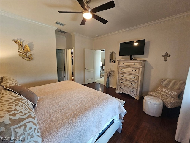 bedroom featuring a walk in closet, a closet, ceiling fan, dark wood-type flooring, and ornamental molding