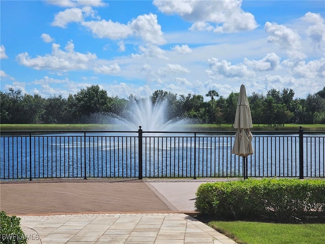 view of swimming pool with a water view