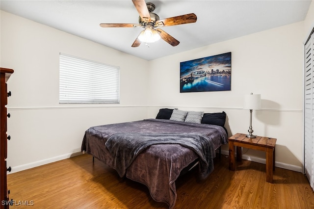 bedroom with ceiling fan and wood-type flooring