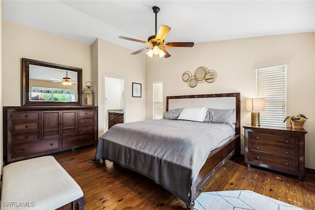 bedroom with connected bathroom, dark hardwood / wood-style floors, ceiling fan, and lofted ceiling