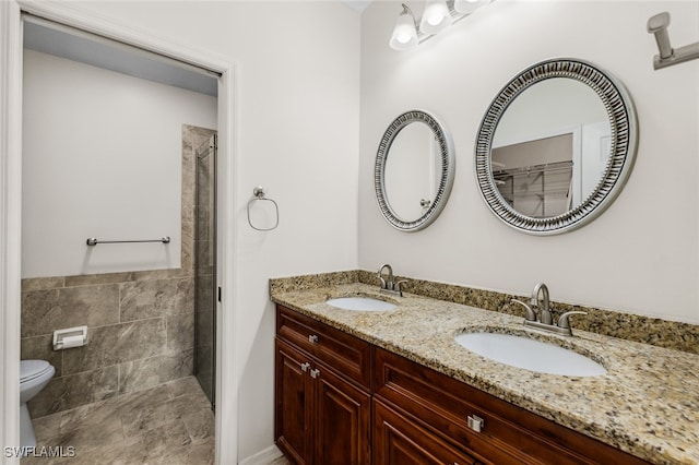 bathroom with vanity, toilet, walk in shower, and tile walls