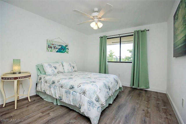 bedroom with ceiling fan and dark hardwood / wood-style flooring