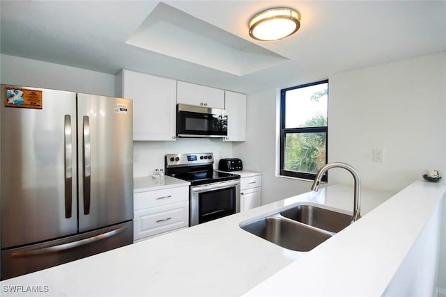 kitchen featuring white cabinetry, sink, and appliances with stainless steel finishes