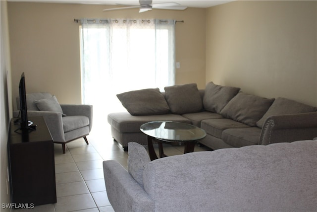 tiled living room with ceiling fan