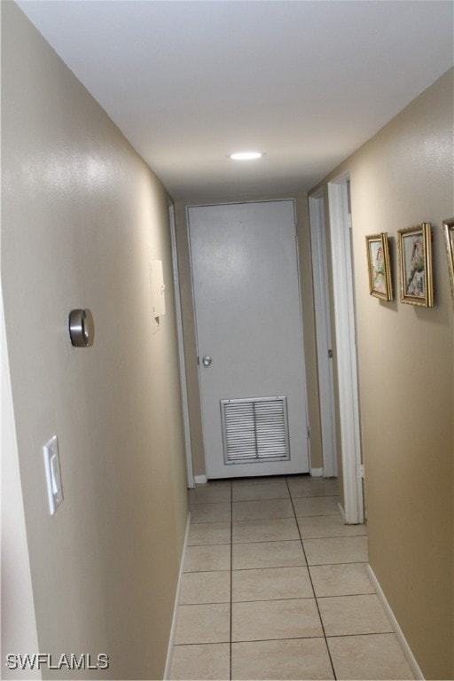 corridor featuring light tile patterned floors