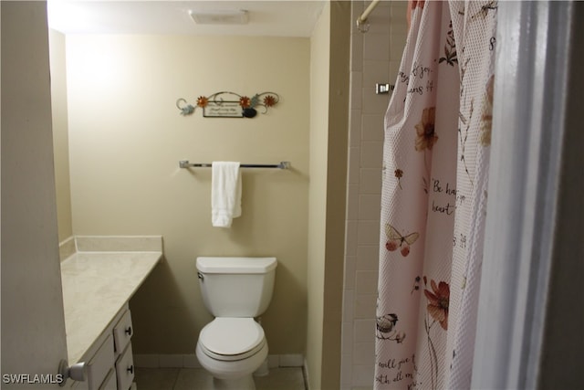 bathroom with toilet, vanity, tile patterned flooring, and walk in shower