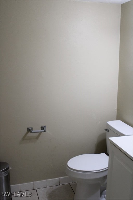 bathroom featuring vanity, tile patterned flooring, and toilet