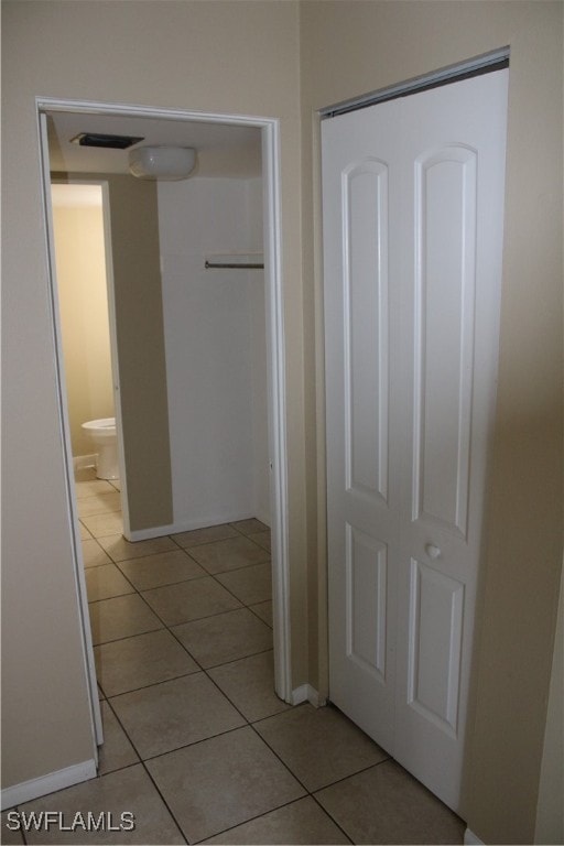 hallway featuring light tile patterned flooring