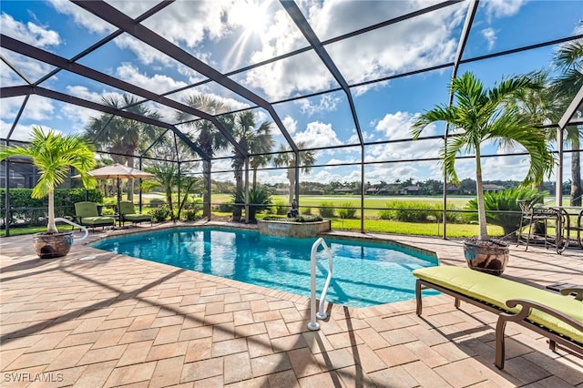 view of pool with a patio area, pool water feature, and glass enclosure