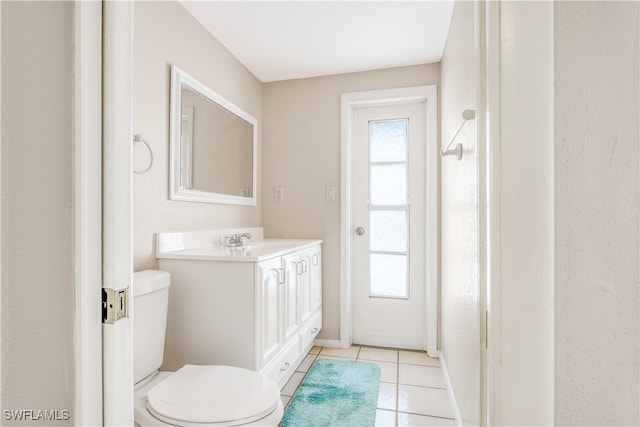 bathroom featuring vanity, toilet, and tile patterned floors