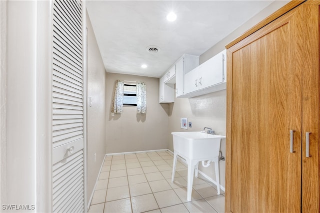 laundry area with washer hookup and light tile patterned floors