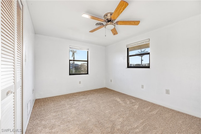 unfurnished bedroom featuring carpet floors, a closet, and ceiling fan