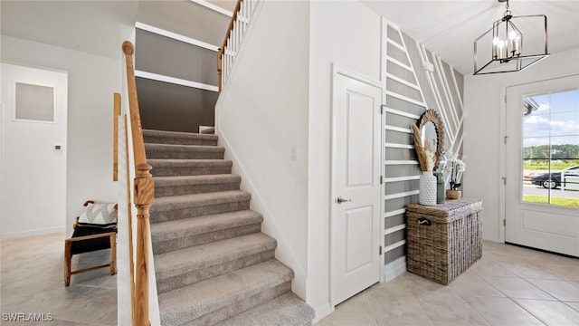 tiled entryway with an inviting chandelier