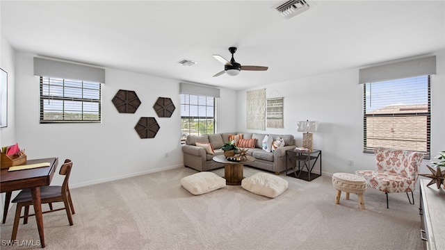 carpeted living room featuring ceiling fan