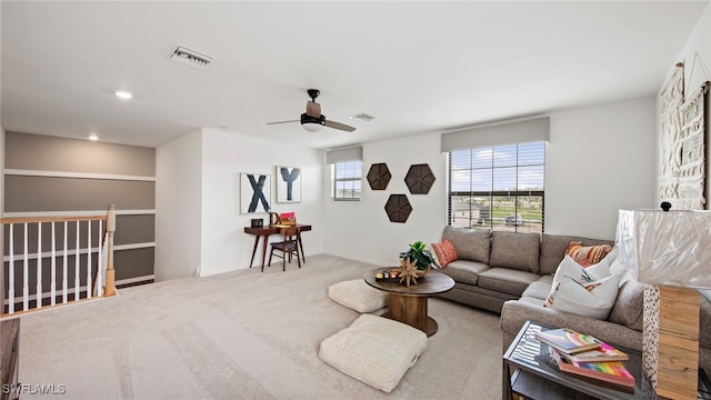 carpeted living room with ceiling fan