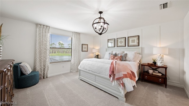 carpeted bedroom featuring an inviting chandelier