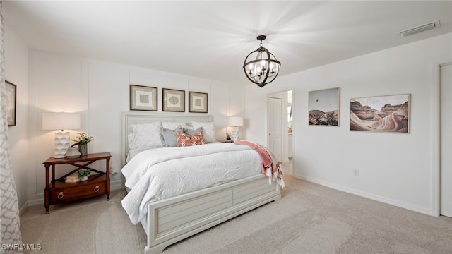 carpeted bedroom with ensuite bath and an inviting chandelier