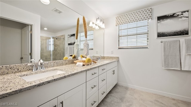 bathroom featuring vanity, an enclosed shower, and tile patterned floors