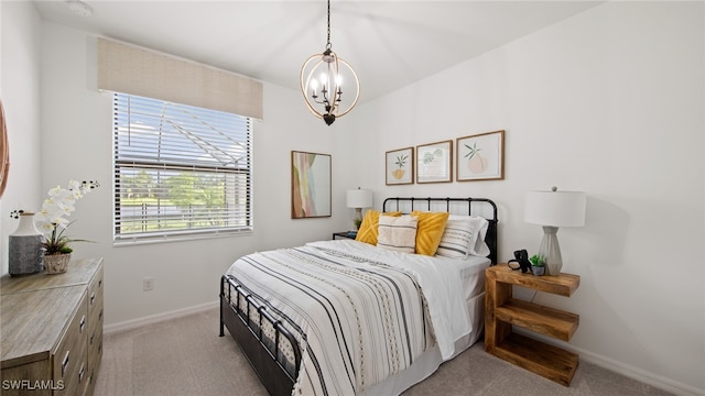 bedroom featuring light carpet and a notable chandelier