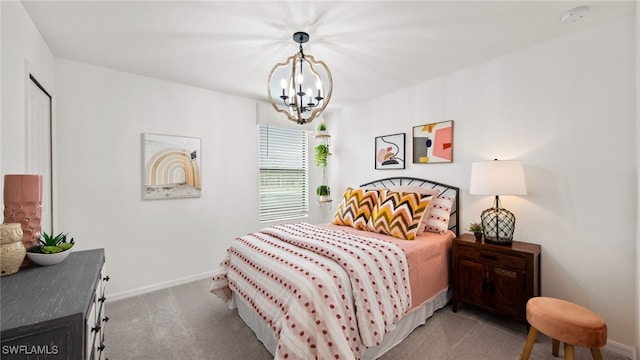 bedroom with carpet and a notable chandelier