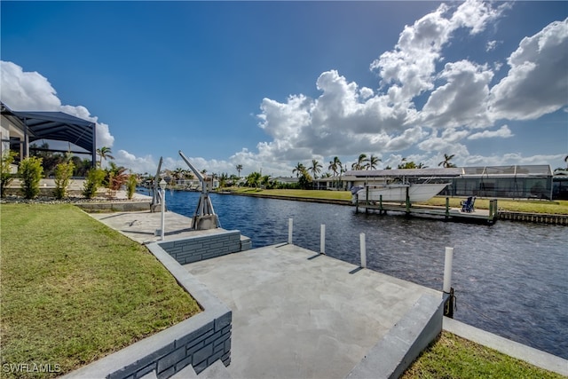 view of dock with a water view and a yard