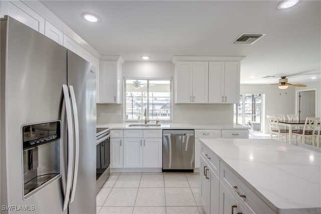 kitchen featuring white cabinetry, ceiling fan, stainless steel appliances, and sink